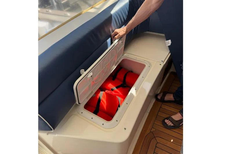 Slide: The Image of Storage compartment on 2006 Sabre 38 Salon Express yacht, revealing life jackets. - 12