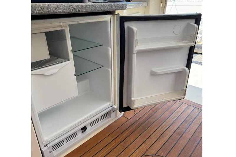 Slide: The Image of Open refrigerator on 2006 Sabre 38 Salon Express yacht with wooden flooring. - 14