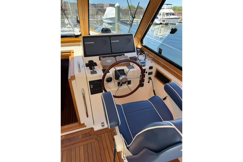 Slide: The Image of Helm of 2006 Sabre 38 Salon Express with dual Furuno displays and wooden steering wheel. - 17