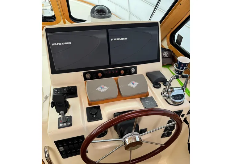 Slide: The Image of Helm of 2006 Sabre 38 Salon Express with dual Furuno displays and wooden steering wheel. - 18