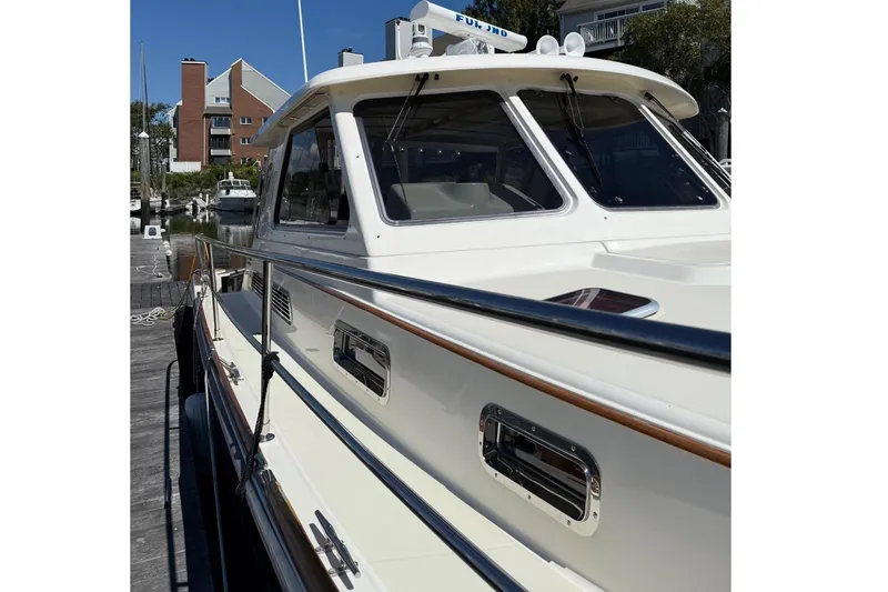 Slide: The Image of 2006 Sabre 38 Salon Express yacht docked under clear blue sky. - 2