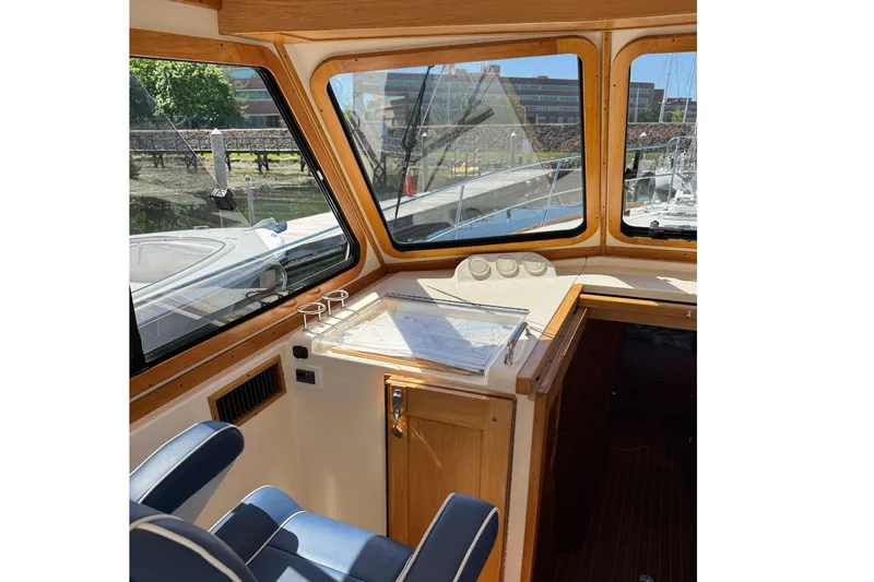 Slide: The Image of Interior of 2006 Sabre 38 Salon Express yacht with blue seating and wooden accents. - 20