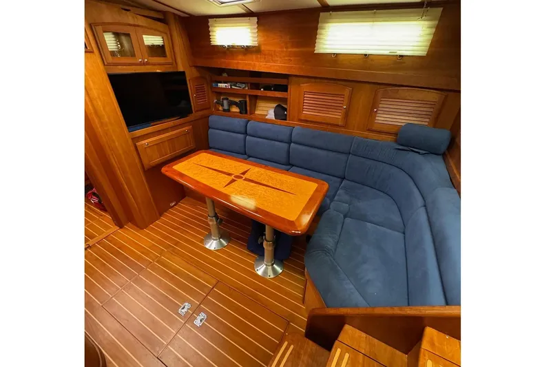 Slide: The Image of Luxurious interior of 2006 Sabre 38 Salon Express with blue seating and wooden table. - 21