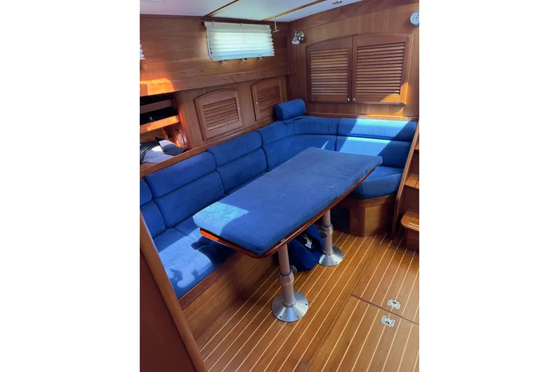 Slide: The Image of Interior of 2006 Sabre 38 Salon Express with blue seating and wooden accents. - 23