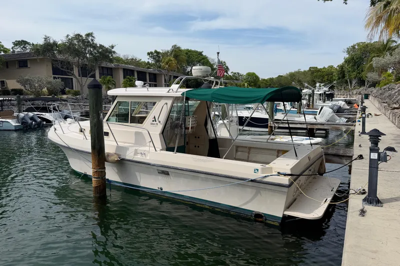 The Image of 2005 Albin 28 Tournament Express boat docked at marina with green canopy. - 0