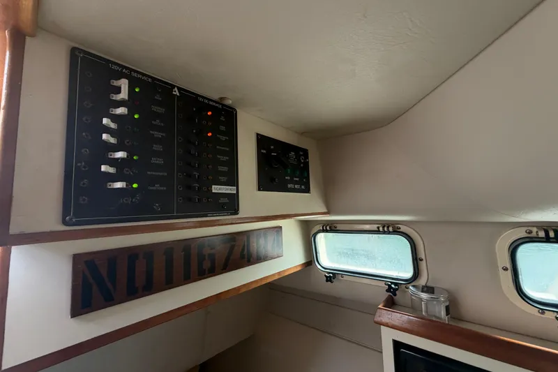 Slide: The Image of Electrical panel inside 2005 Albin 28 Tournament Express boat cabin with windows. - 15