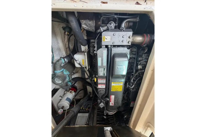 Slide: The Image of Engine compartment of a 2005 Albin 28 Tournament Express boat, showcasing mechanical components. - 16