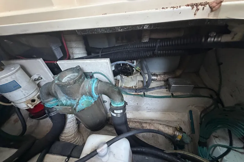 Slide: The Image of Engine compartment of a 2005 Albin 28 Tournament Express boat, showing various mechanical components. - 17