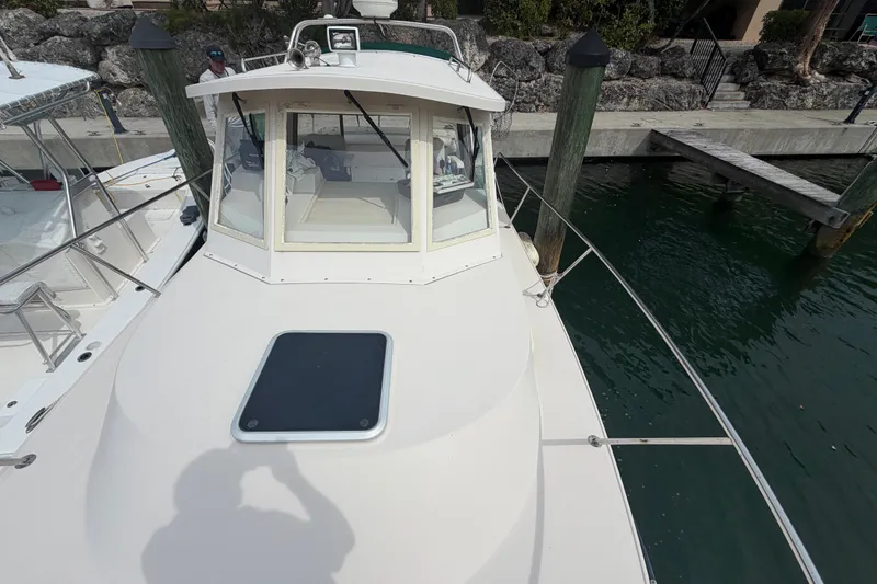 Slide: The Image of 2005 Albin 28 Tournament Express boat docked, showcasing cabin and deck features. - 24