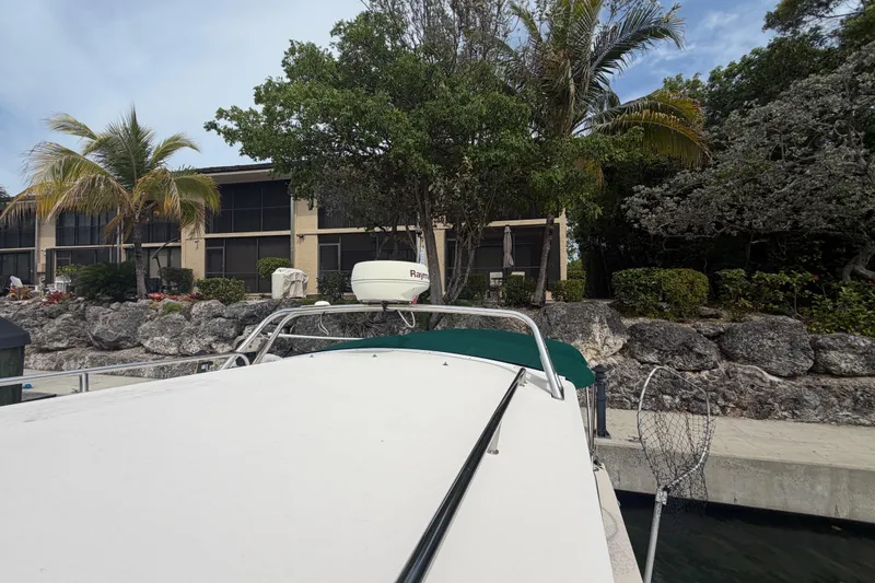 Slide: The Image of 2005 Albin 28 Tournament Express docked near tropical landscaping. - 25