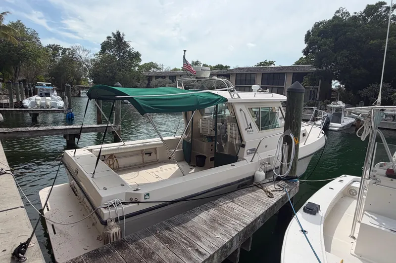 Slide: The Image of 2005 Albin 28 Tournament Express docked at marina with green canopy. - 3