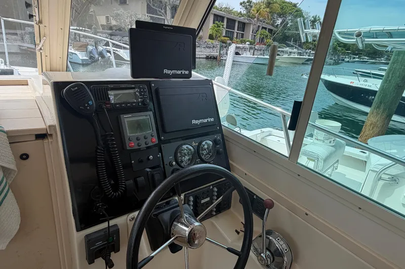 Slide: The Image of Helm of 2005 Albin 28 Tournament Express with Raymarine electronics, docked in marina. - 4