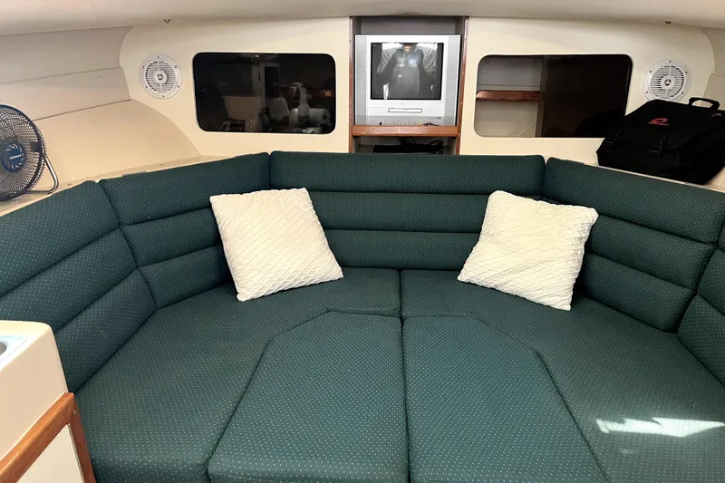 Slide: The Image of Interior of 2005 Albin 28 Tournament Express with green cushioned seating and TV. - 6