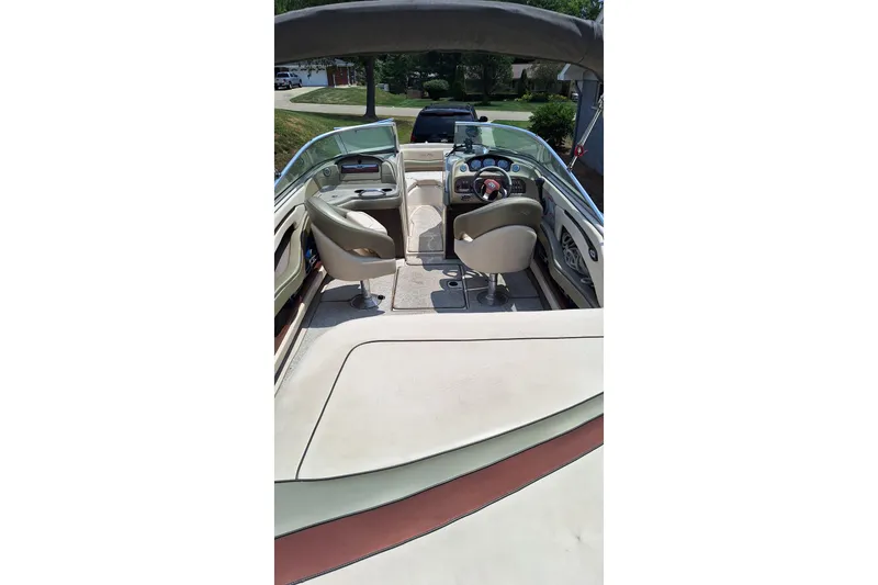Slide: The Image of 2004 Sea Ray 240 Select boat interior with steering wheel and seating. - 12