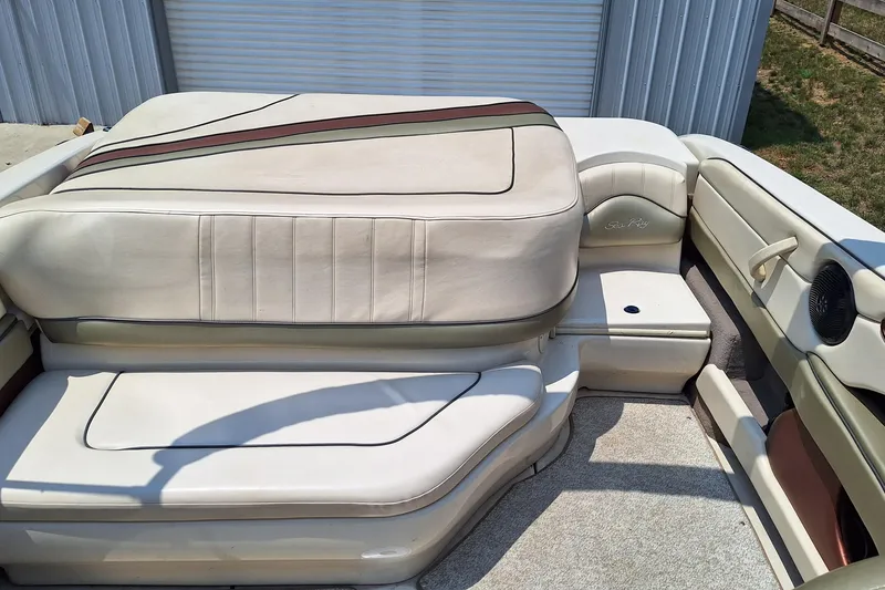 Slide: The Image of 2004 Sea Ray 240 Select boat interior with beige seating and brown accents. - 16