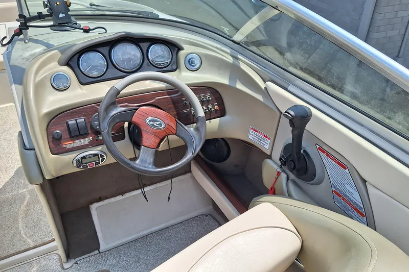 Slide: The Image of Interior view of 2004 Sea Ray 240 Select boat dashboard and steering wheel. - 18