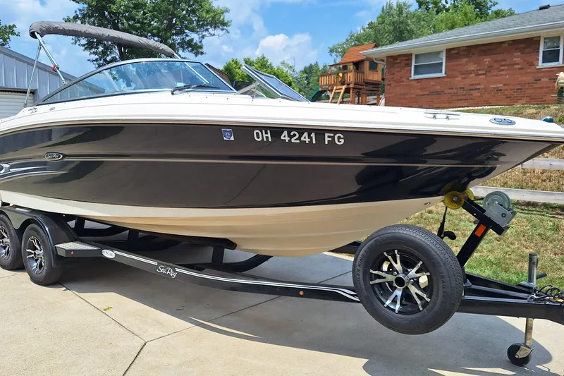 Slide: The Image of 2004 Sea Ray 240 Select boat on trailer in residential driveway. - 2