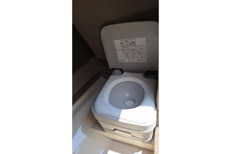 Slide: The Image of Portable toilet inside 2004 Sea Ray 240 Select boat cabin. - 21