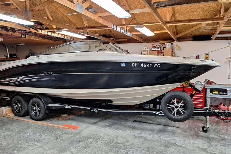 Slide: The Image of 2004 Sea Ray 240 Select boat on trailer in a garage setting. - 25