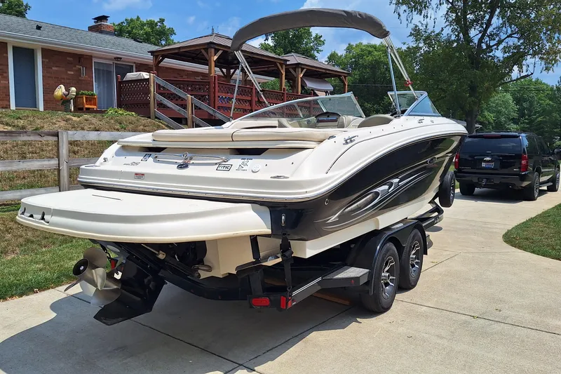 Slide: The Image of 2004 Sea Ray 240 Select boat on trailer, parked in driveway near house and SUV. - 5