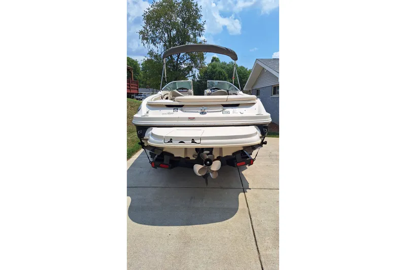 Slide: The Image of 2004 Sea Ray 240 Select boat parked on driveway, rear view. - 6