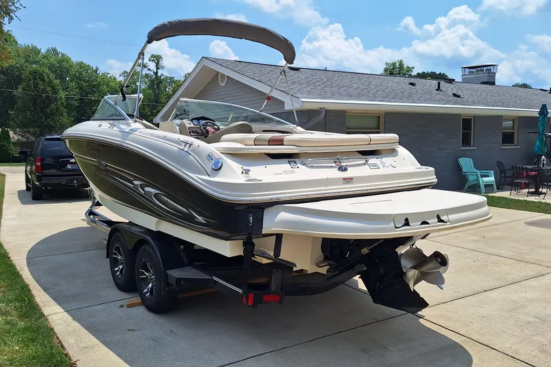 Slide: The Image of 2004 Sea Ray 240 Select boat on trailer in driveway, sunny day. - 7
