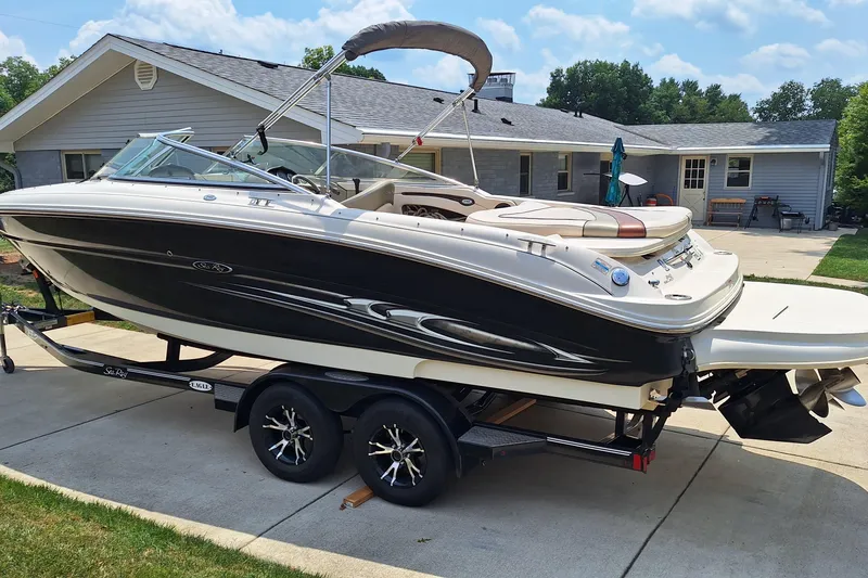 Slide: The Image of 2004 Sea Ray 240 Select boat on trailer, parked in driveway near house. - 8