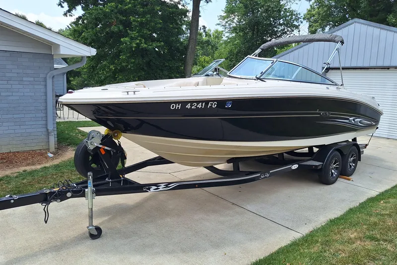 Slide: The Image of 2004 Sea Ray 240 Select boat on trailer, parked in driveway. - 9