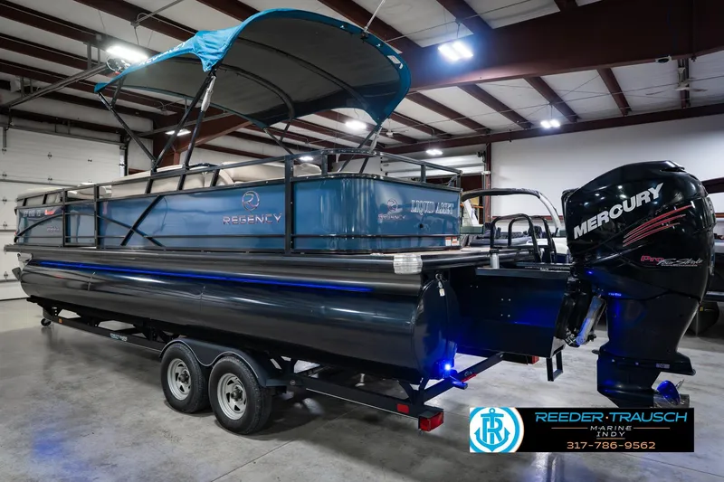 Slide: The Image of 2018 Regency 254 DL3 pontoon boat with Mercury engine in indoor showroom. - 10