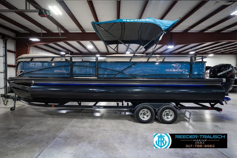 Slide: The Image of 2018 Regency 254 DL3 pontoon boat with canopy in indoor showroom. - 12