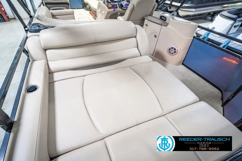 Slide: The Image of Luxurious seating on 2018 Regency 254 DL3 pontoon boat, featuring beige upholstery and cup holders. - 17