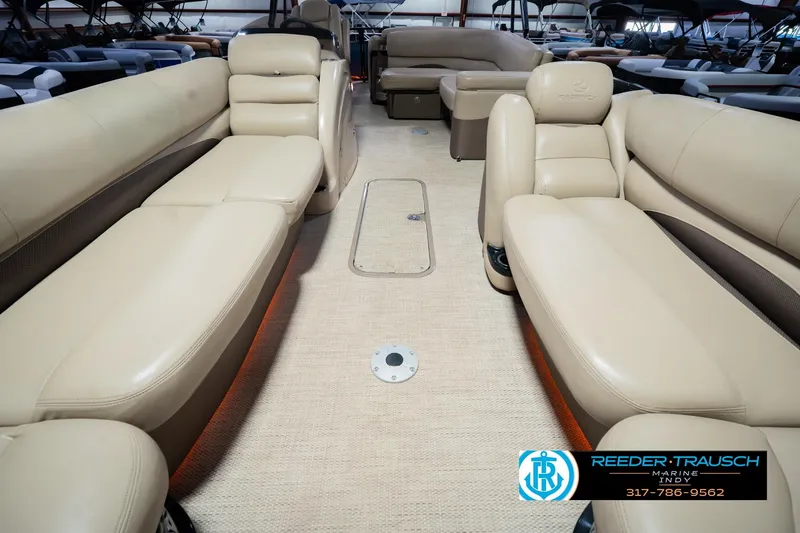 Slide: The Image of Interior of a 2018 Regency 254 DL3 pontoon boat with beige seating. - 18