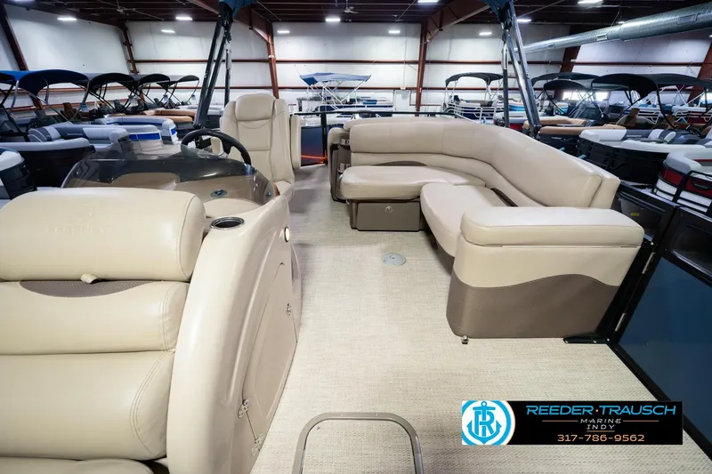 Slide: The Image of Interior of 2018 Regency 254 DL3 pontoon boat with beige seating in showroom. - 20
