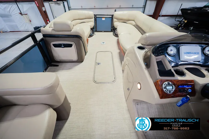 Slide: The Image of Luxurious interior of 2018 Regency 254 DL3 pontoon boat with plush seating and modern dashboard. - 24