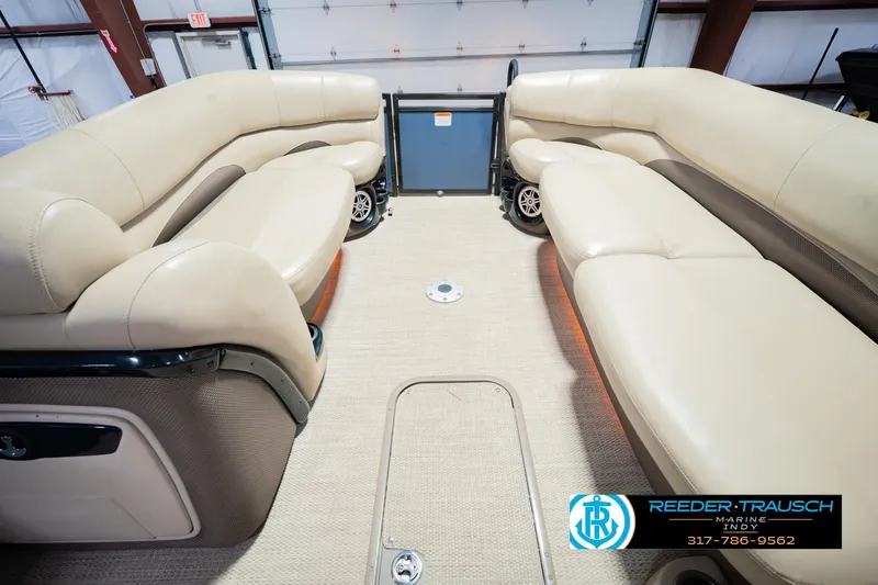 Slide: The Image of Interior of 2018 Regency 254 DL3 pontoon boat with beige seating and carpet flooring. - 25