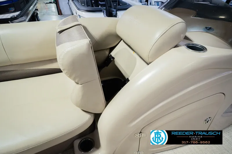 Slide: The Image of 2018 Regency 254 DL3 boat interior with beige seating and cup holder. - 29