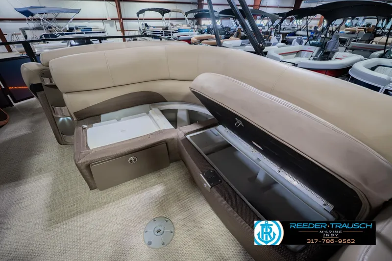 Slide: The Image of 2018 Regency 254 DL3 pontoon boat interior with storage compartments open, showcasing seating and amenities. - 32