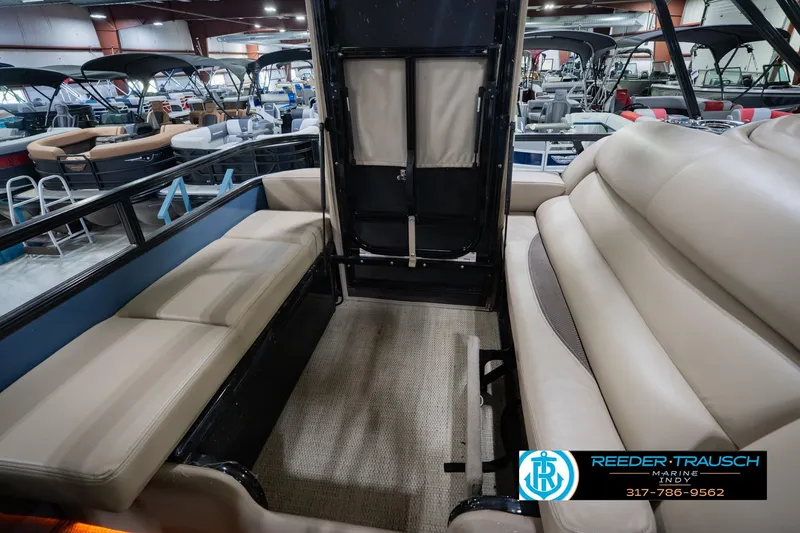 Slide: The Image of Interior of 2018 Regency 254 DL3 pontoon boat with beige seating in showroom. - 36