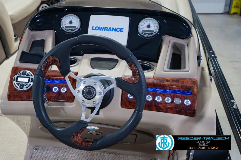 Slide: The Image of 2018 Regency 254 DL3 boat dashboard with steering wheel and Lowrance display. - 37