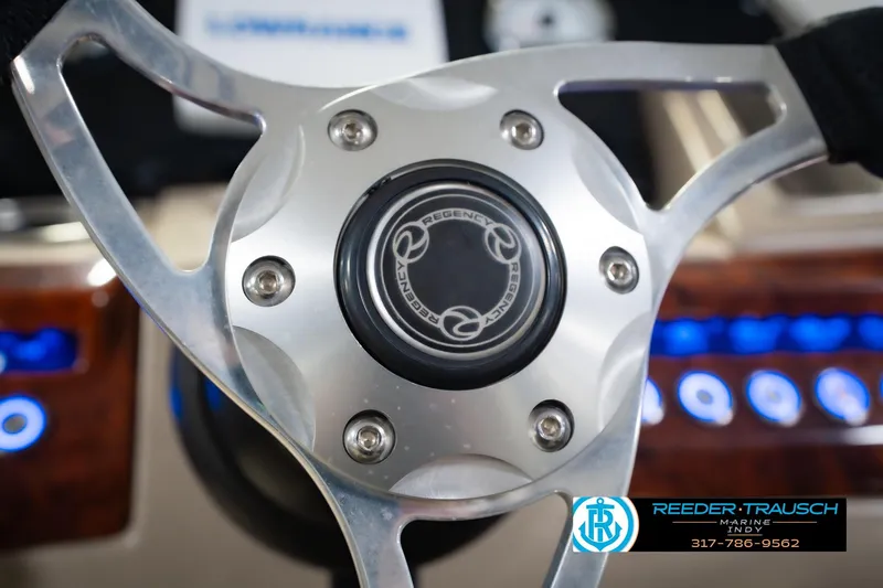 Slide: The Image of Steering wheel of 2018 Regency 254 DL3 boat with logo and control panel. - 39