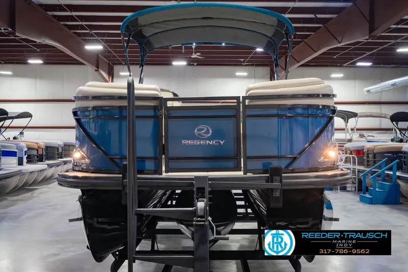 Slide: The Image of 2018 Regency 254 DL3 pontoon boat in showroom, rear view with canopy. - 4