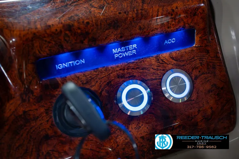 Slide: The Image of Control panel of 2018 Regency 254 DL3 boat with ignition and power buttons. - 41