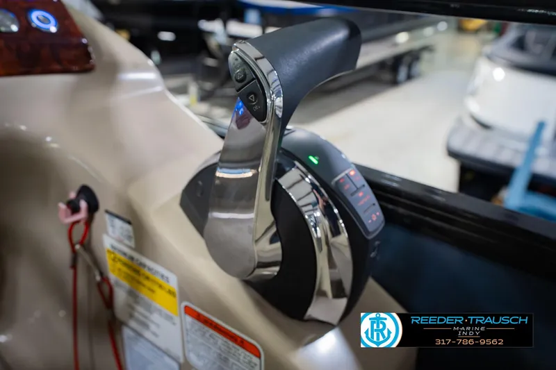 Slide: The Image of Close-up of 2018 Regency 254 DL3 boat throttle control in a showroom. - 46