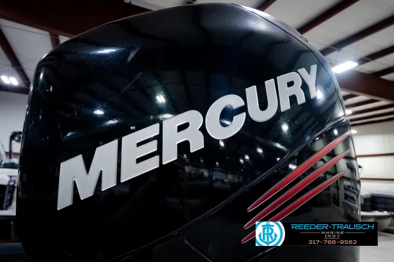 Slide: The Image of 2018 Regency 254 DL3 with Mercury engine in showroom, Reeder Trausch Marine logo visible. - 57