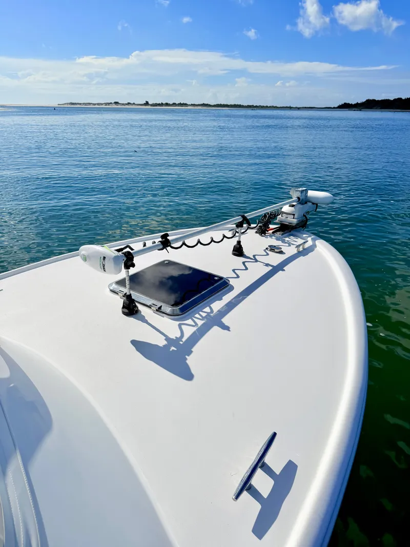 Slide: The Image of Bow of a 1973 Custom Carolina 27 National boat on calm water. - 10