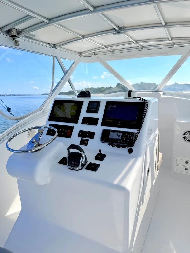 Slide: The Image of Helm of 1973 Custom Carolina 27 National on calm waters. - 16