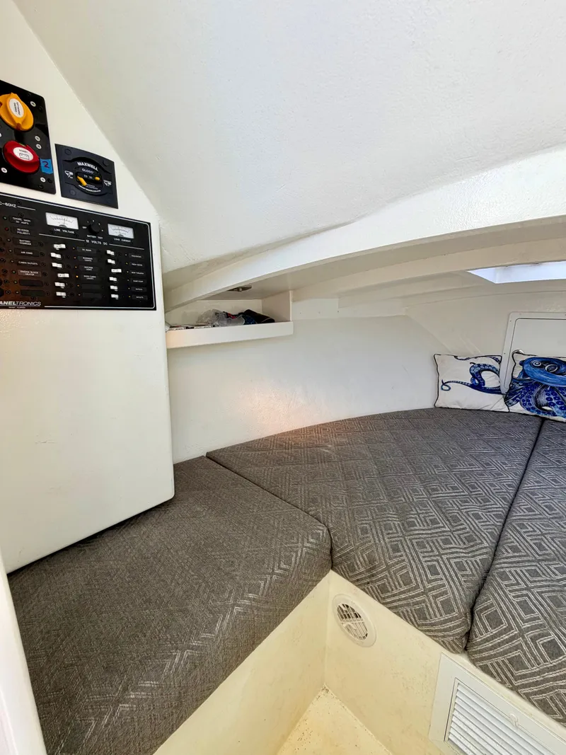Slide: The Image of Interior of a 1973 Custom Carolina 27 National boat with gray cushions. - 25
