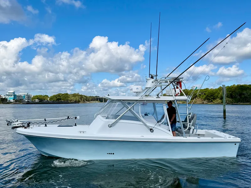 Slide: The Image of 1973 Custom Carolina 27 National boat on calm waters. - 3