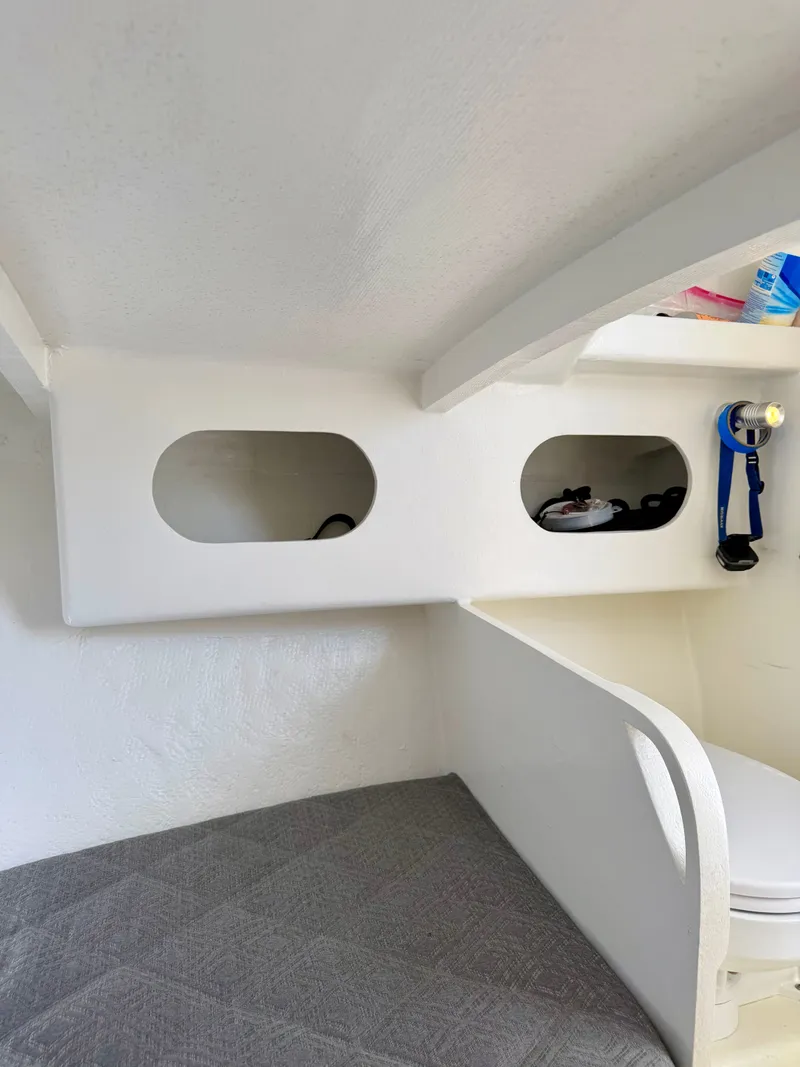 Slide: The Image of Interior of a 1973 Custom Carolina 27 National boat with storage compartments. - 30