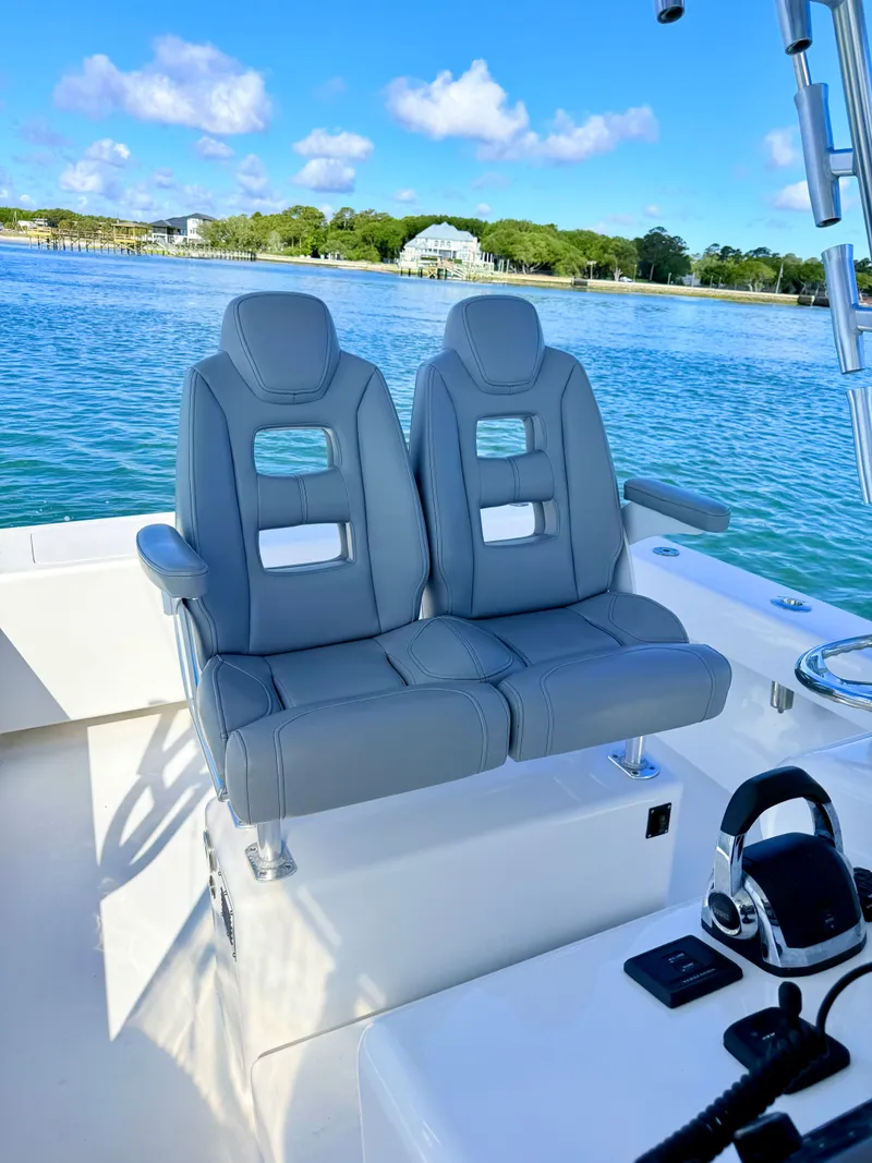 Slide: The Image of Two gray seats on a 1973 Custom Carolina 27 National boat. - 37